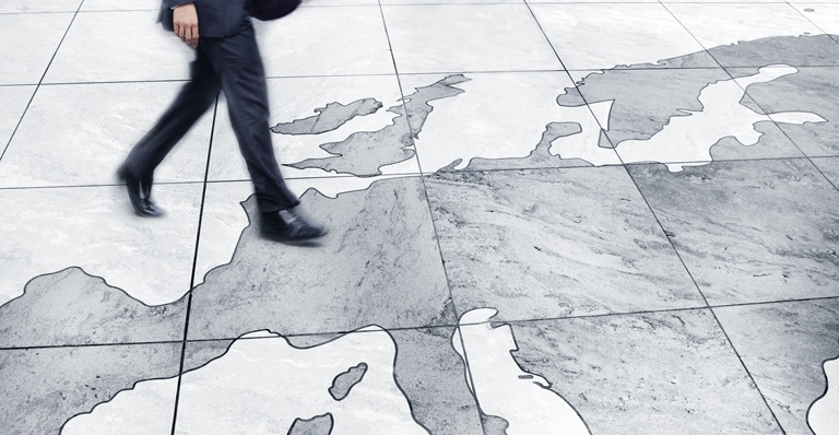 Man walking on floor map of Europe.